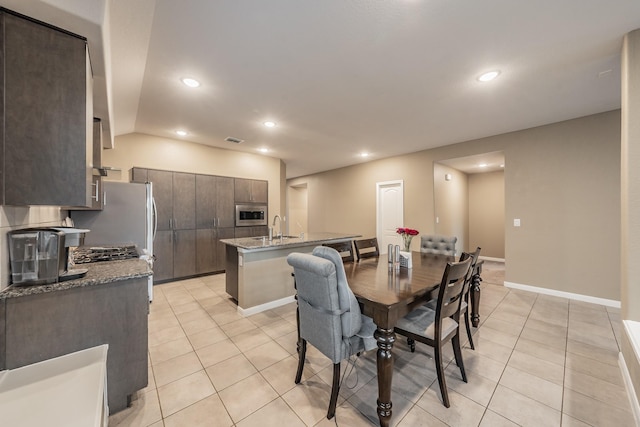 dining room with light tile patterned floors, baseboards, and recessed lighting