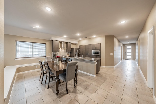 dining space with recessed lighting, baseboards, and light tile patterned floors