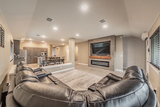 living room featuring lofted ceiling, a large fireplace, visible vents, and recessed lighting