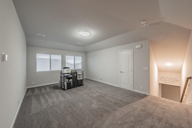 unfurnished office featuring lofted ceiling, baseboards, and dark carpet