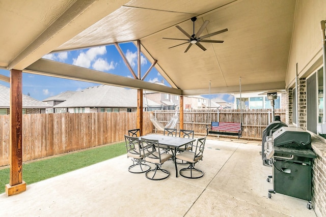 view of patio featuring a ceiling fan, fence private yard, outdoor dining area, and grilling area