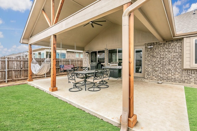 view of patio featuring outdoor dining space, fence, and ceiling fan