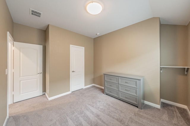 unfurnished bedroom featuring carpet flooring, visible vents, and baseboards