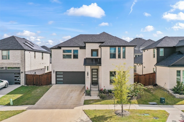 view of front of house featuring an attached garage, fence, concrete driveway, roof with shingles, and a residential view