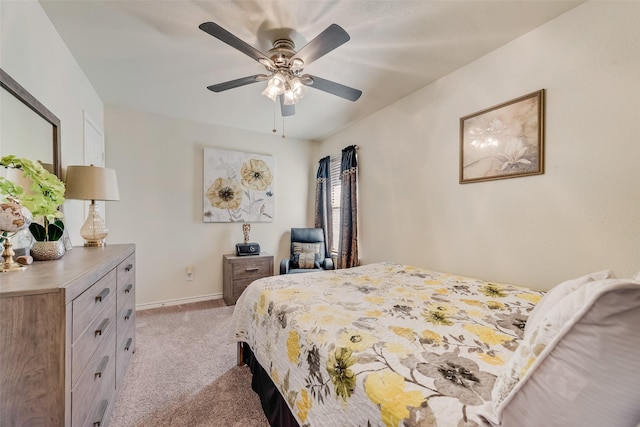 bedroom with light carpet, ceiling fan, and baseboards