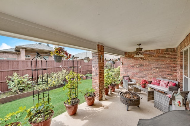 view of patio / terrace featuring a garden, an outdoor fire pit, and fence