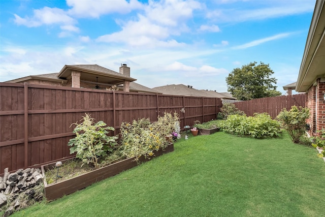 view of yard with a fenced backyard and a vegetable garden