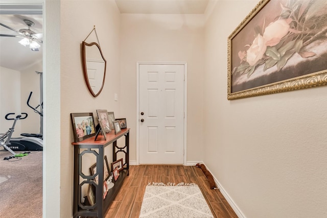 hallway featuring baseboards and wood tiled floor