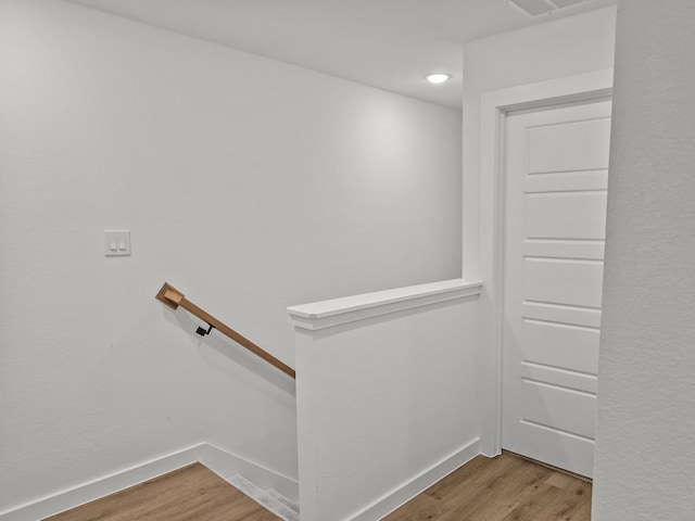 stairway with baseboards and wood finished floors