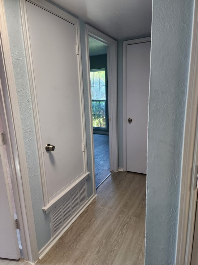 bathroom featuring wood finished floors and visible vents
