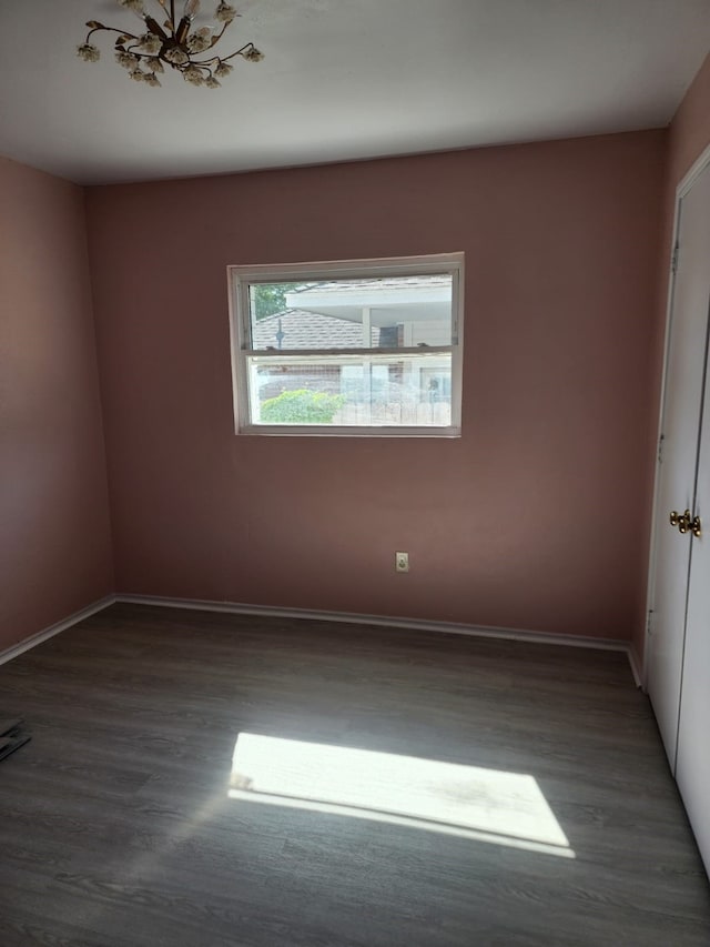 unfurnished room with wood finished floors and baseboards