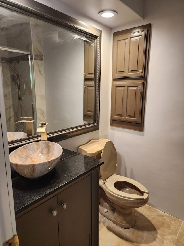 full bath with toilet, vanity, and a stall shower