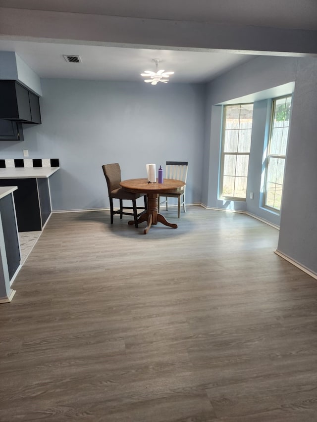 dining area featuring a notable chandelier, visible vents, dark wood-style flooring, and beamed ceiling