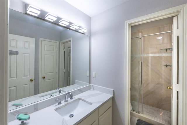 full bath featuring toilet, a shower stall, and vanity