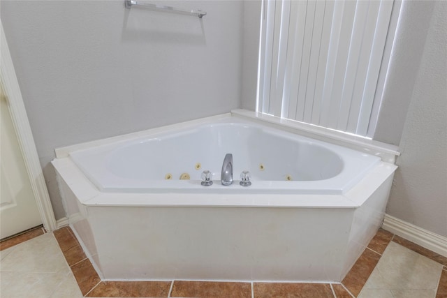 full bathroom with a jetted tub and tile patterned floors