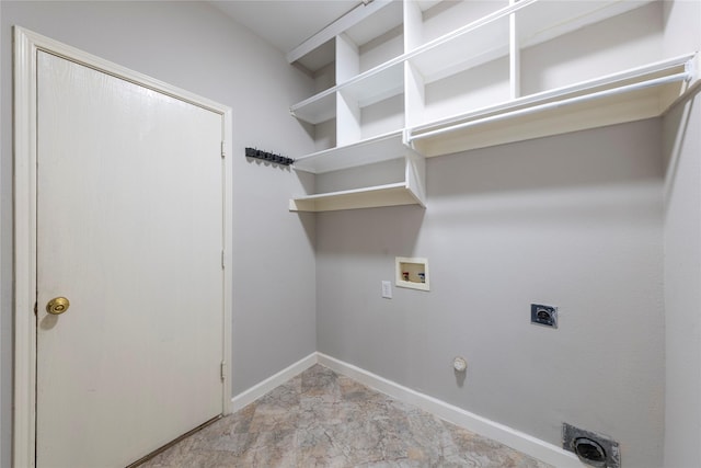 clothes washing area with hookup for a washing machine, hookup for a gas dryer, hookup for an electric dryer, laundry area, and baseboards