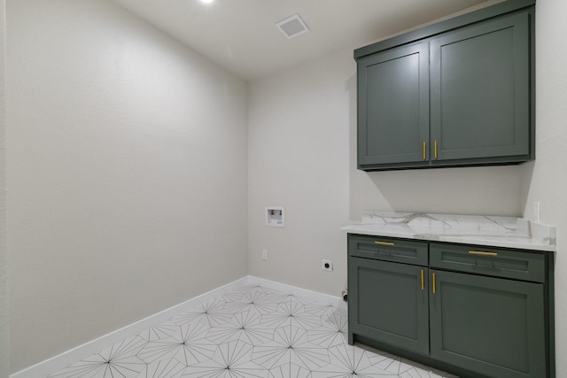 clothes washing area with cabinet space, visible vents, baseboards, hookup for an electric dryer, and washer hookup