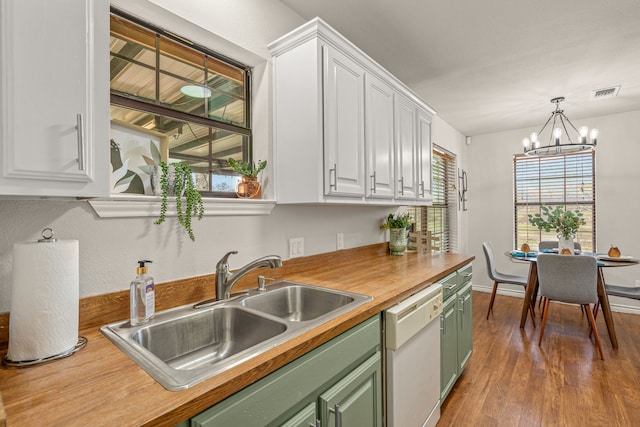 kitchen with green cabinets, dishwasher, wood finished floors, white cabinets, and a sink