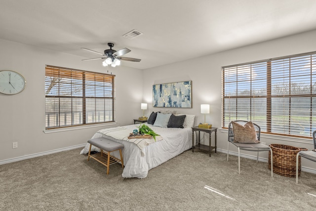 carpeted bedroom featuring visible vents, ceiling fan, and baseboards