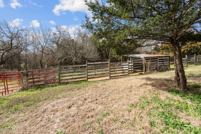 view of yard featuring an outbuilding and a rural view