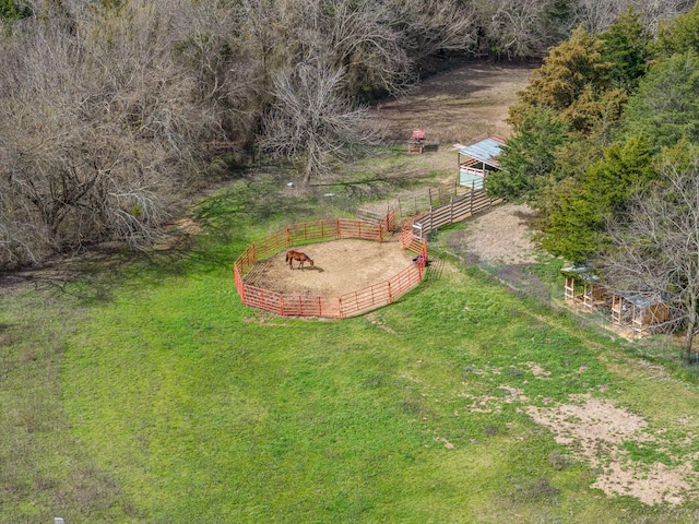 view of yard featuring an outdoor structure, an enclosed area, and an exterior structure