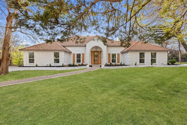 300 Covey Ln, Mckinney, TX 75071 - mediterranean / spanish-style home featuring brick siding, a tile roof, and a front yard
