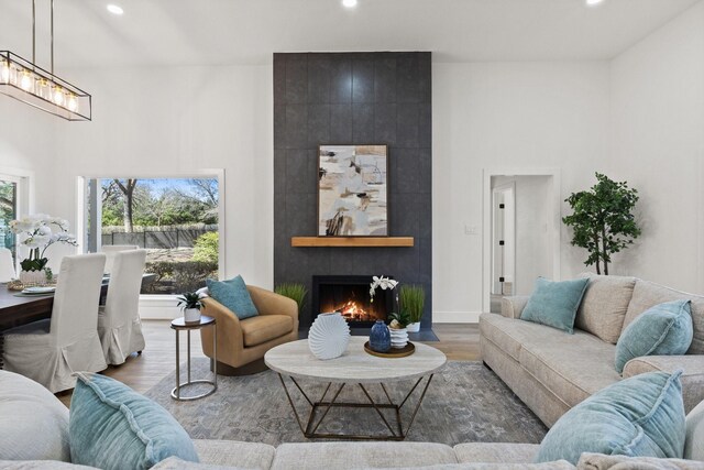 300 Covey Ln, Mckinney, TX 75071 - living area with a fireplace, a high ceiling, recessed lighting, and wood finished floors