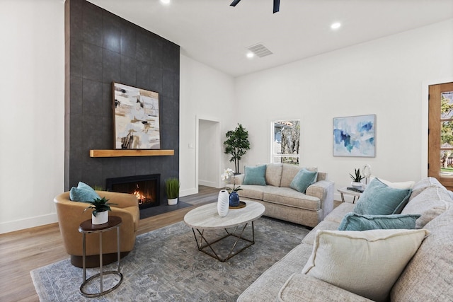 300 Covey Ln, Mckinney, TX 75071 - living area featuring wood finished floors, visible vents, baseboards, a fireplace, and ceiling fan