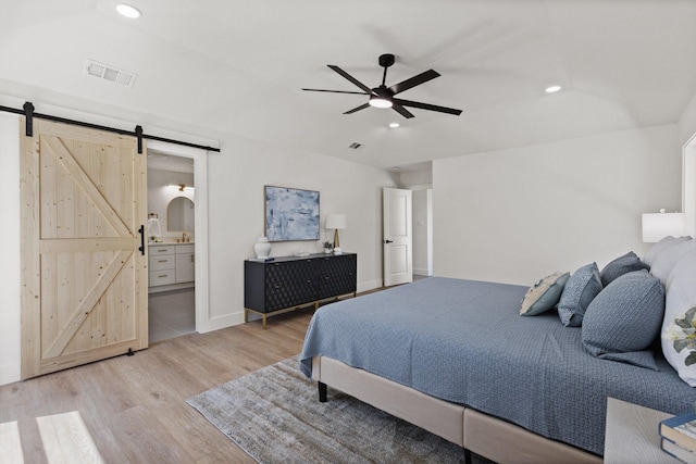 300 Covey Ln, Mckinney, TX 75071 - bedroom with recessed lighting, a barn door, ensuite bath, and light wood finished floors