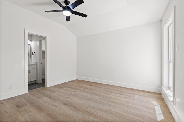 300 Covey Ln, Mckinney, TX 75071 - unfurnished bedroom featuring lofted ceiling, baseboards, light wood finished floors, and connected bathroom