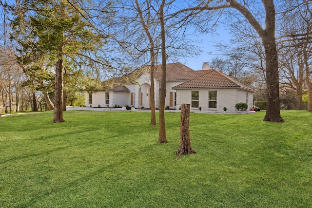 300 Covey Ln, Mckinney, TX 75071 - mediterranean / spanish house featuring brick siding, a tiled roof, a chimney, and a front yard