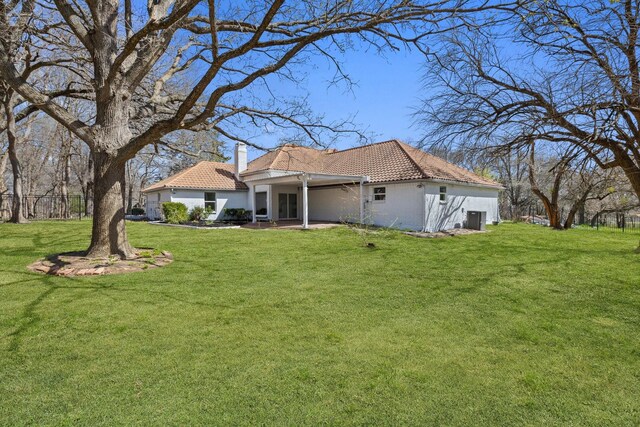 300 Covey Ln, Mckinney, TX 75071 - rear view of property with a patio, a yard, central AC, a chimney, and a tiled roof