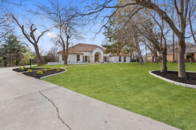 300 Covey Ln, Mckinney, TX 75071 - mediterranean / spanish-style house with stucco siding, concrete driveway, and a front lawn