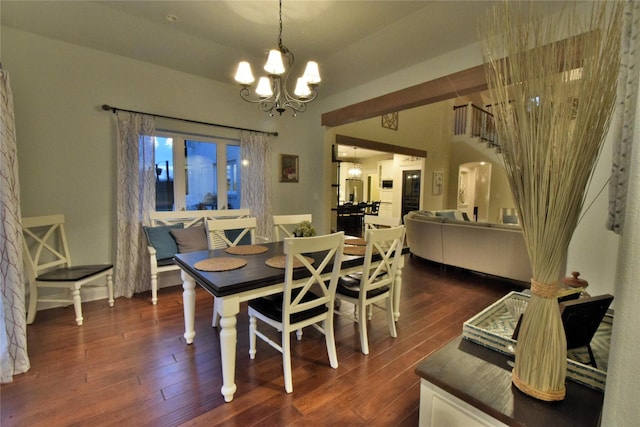 dining space featuring dark wood-style floors and a chandelier