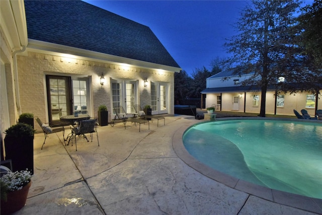 pool with a patio and french doors