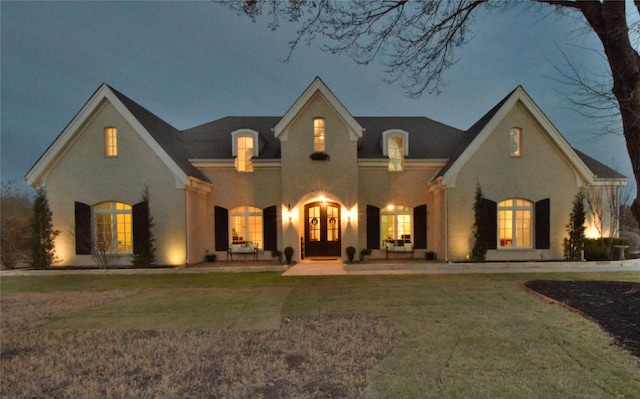 french country style house with a front yard