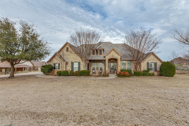 french country inspired facade with stone siding