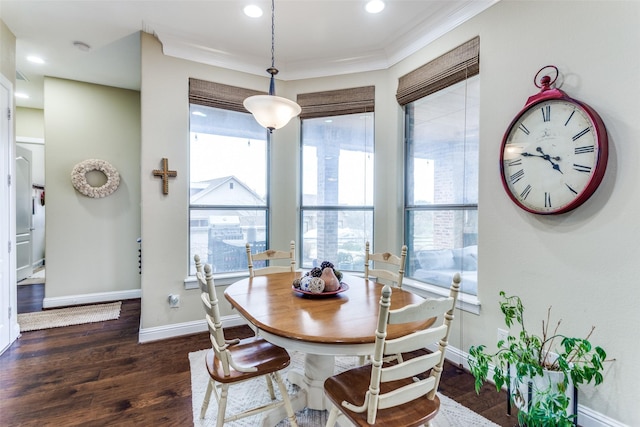 dining area with recessed lighting, crown molding, baseboards, and wood finished floors