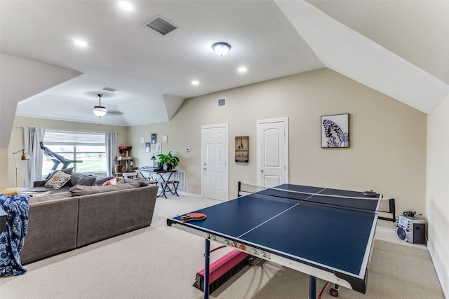 rec room with visible vents, vaulted ceiling, and carpet flooring