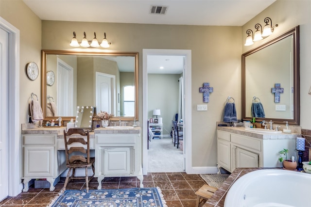 bathroom featuring two vanities, a sink, visible vents, and baseboards