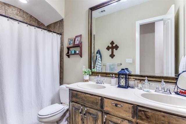 full bathroom with visible vents, a sink, toilet, and double vanity