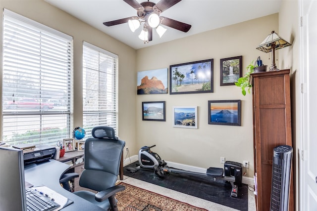 office with ceiling fan and baseboards