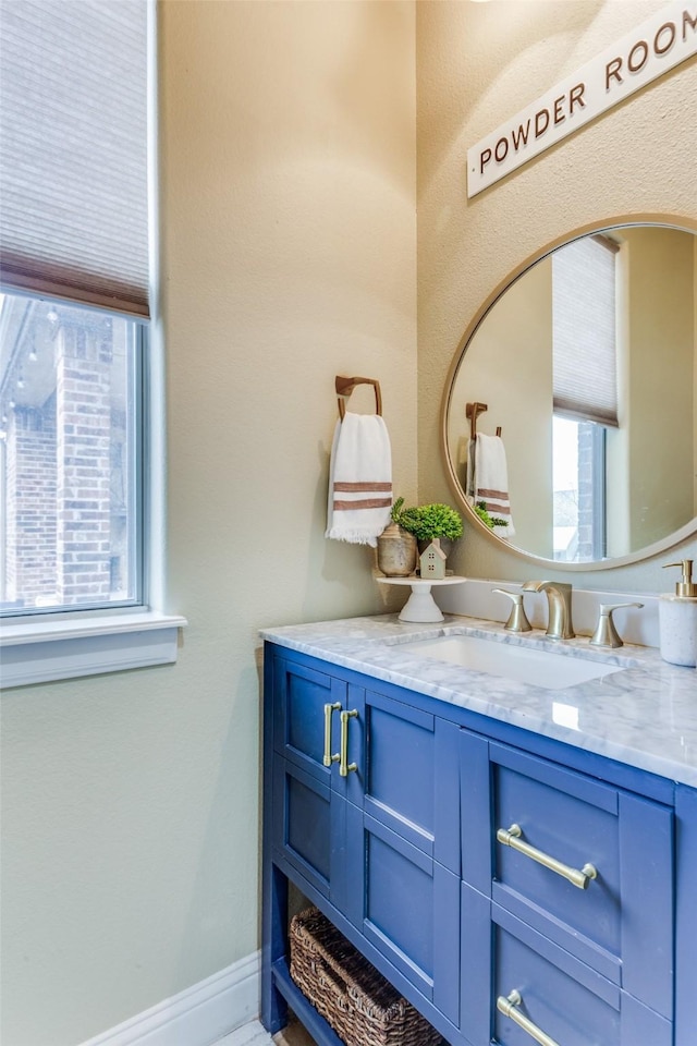 bathroom featuring baseboards and vanity