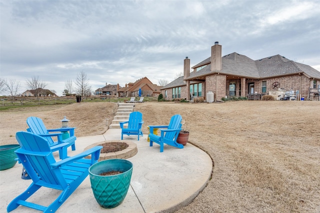 exterior space with an outdoor fire pit and a patio area