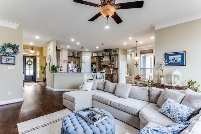 living room with ornamental molding, dark wood-style flooring, and plenty of natural light