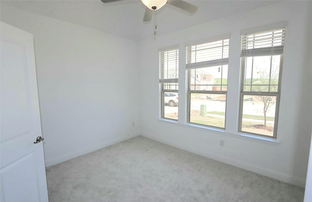 empty room with a ceiling fan, carpet flooring, and baseboards