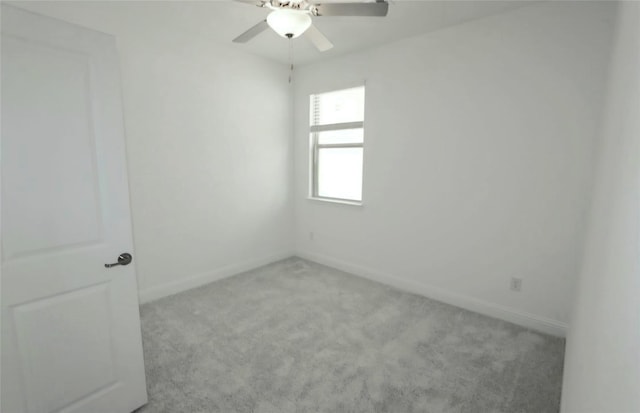 spare room featuring ceiling fan, carpet, and baseboards