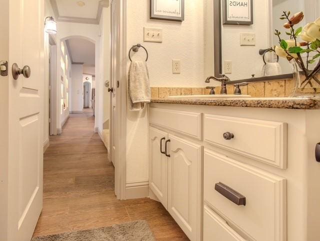 bathroom with vanity and wood finished floors