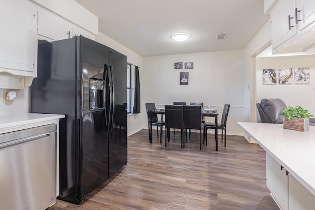 kitchen with dishwasher, light countertops, black fridge with ice dispenser, and visible vents