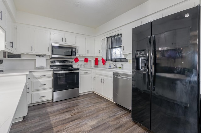 kitchen featuring dark wood-style floors, white cabinetry, and stainless steel appliances